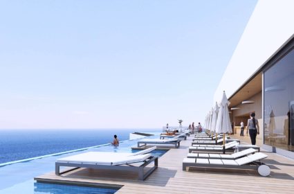 Localizado en un solar privilegiado próximo a la playa de Benidorm, se desarrolla la propuesta de un gran complejo de Spa and Hotel de cinco estrellas a través de una arquitectura singular que se asienta sobre una sierra que disfruta de grandes panorámicas al mar y a la ciudad. Sobre un gran pódium se disponen las actividades recreacionales y de ocio a través de múltiples terrazas que se vinculan a las piscinas, restaurante, el spa-balneario y la zona de eventos, lo que garantiza que estas zonas y las habitaciones en las plantas superiores cuenten en su totalidad con vistas excepcionales y de una excelente orientación. De esta manera, se concentran los espacios comunes en las plantas inferiores para dar lugar a la torre de 40 plantas que alberga las 450 habitaciones y que se corona con un sky-bar en la última planta. Ésta se abre a una infinity pool con una gran terraza con tumbonas, con las mejores vistas del complejo, que está pensado para funcionar todo el año gracias a la zona de eventos y congresos y el SPA con su zona de aguas. Todas las habitaciones tienen vista hacia el mar y se accede a través de un pasillo de servicio situado en la parte trasera. En el interior se han utilizado materiales como la madera en tonos claros para buscar calidez y luminosidad.